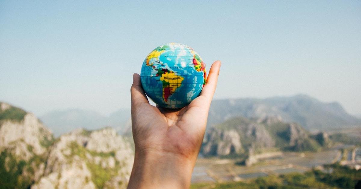 World globe facing mountains