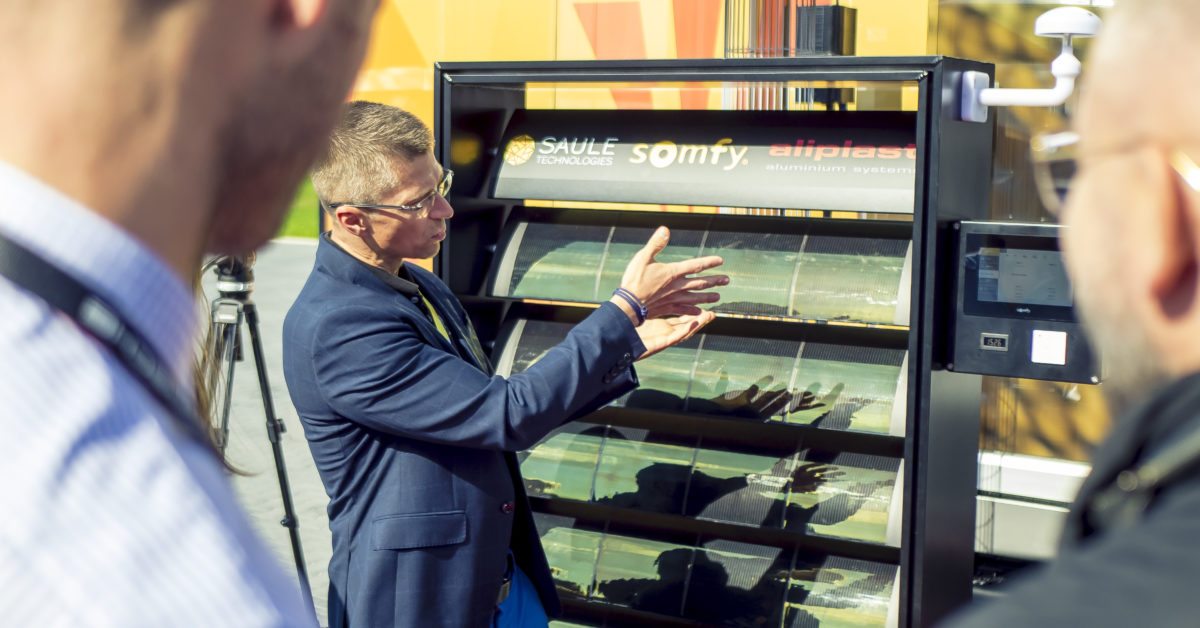 A photograph of the representative from Somfy presenting solar sunblinds demonstrators